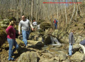 Jeep club spectators watching the best action of the day on the creek rocks