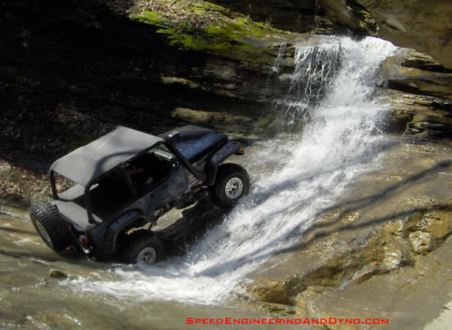 Sonny rinsing the mud from his super swampers